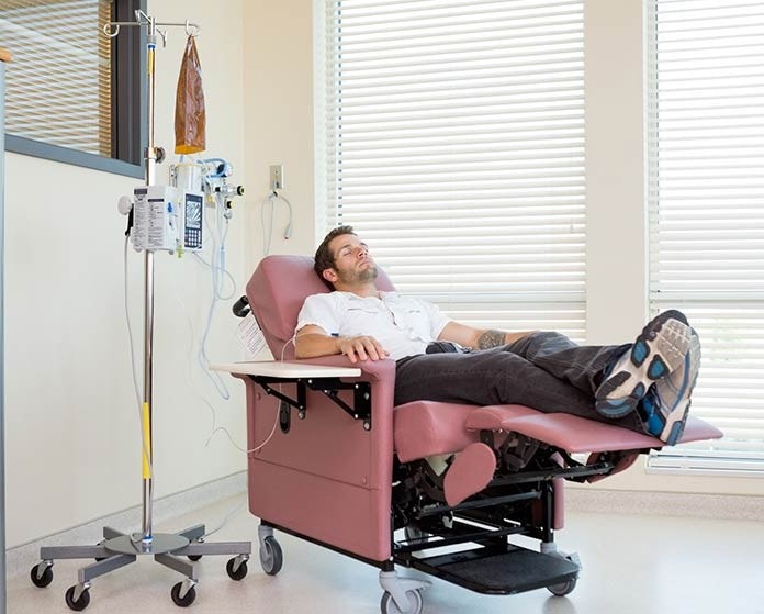 Man getting an infusion treatment inside an infusion suite