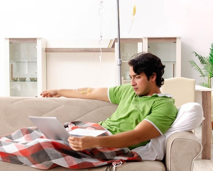 Man at home having an infusion treatment